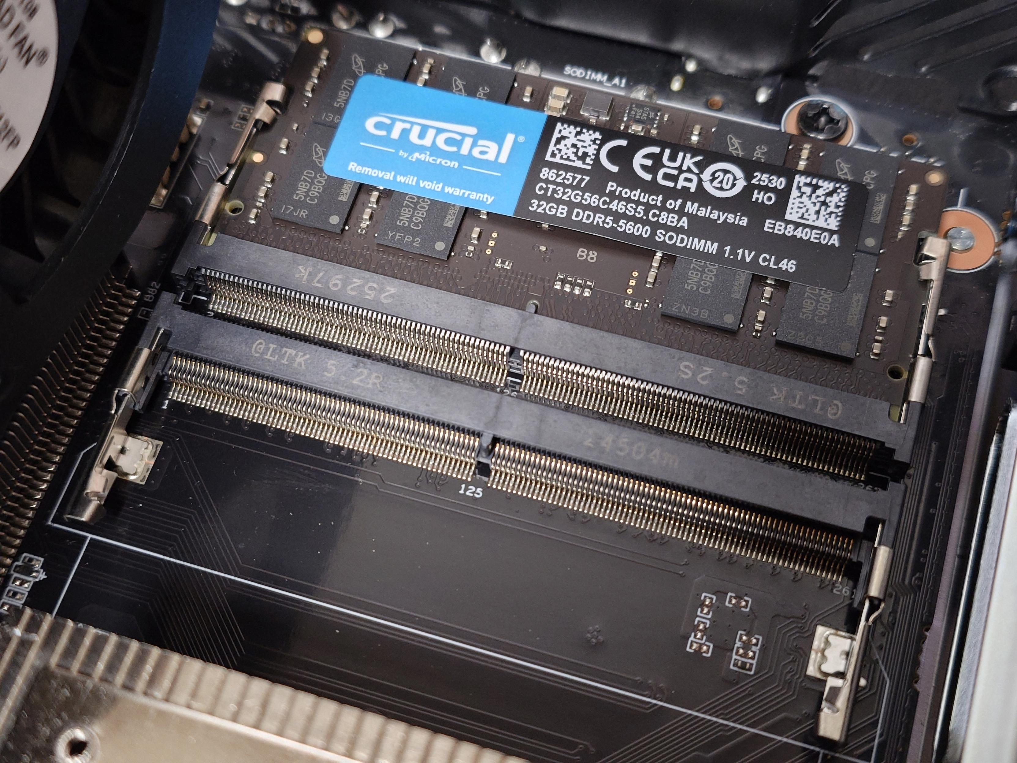 소형 컴퓨터 내부 사진으로, Crucial DDR5 SODIMM 메모리 모듈이 슬롯에 장착됨.